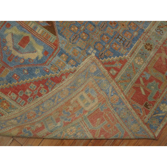 Highly decorative antique early 20th century Persian Malayer rug. Predominant shades in blue and terracotta. 4'10'' x 8'10''