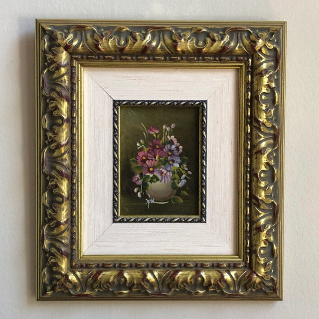 A small and incredibly beautiful late-20th century floral oil-on-board still life presented in a gilded carved wood frame....