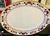 A striking pair of generously sized antique English serving platters decorated in a richly colored Imari-inspired floral...