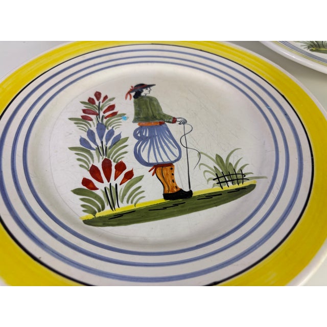 A set of dinner plates by Henriot Quimper.
