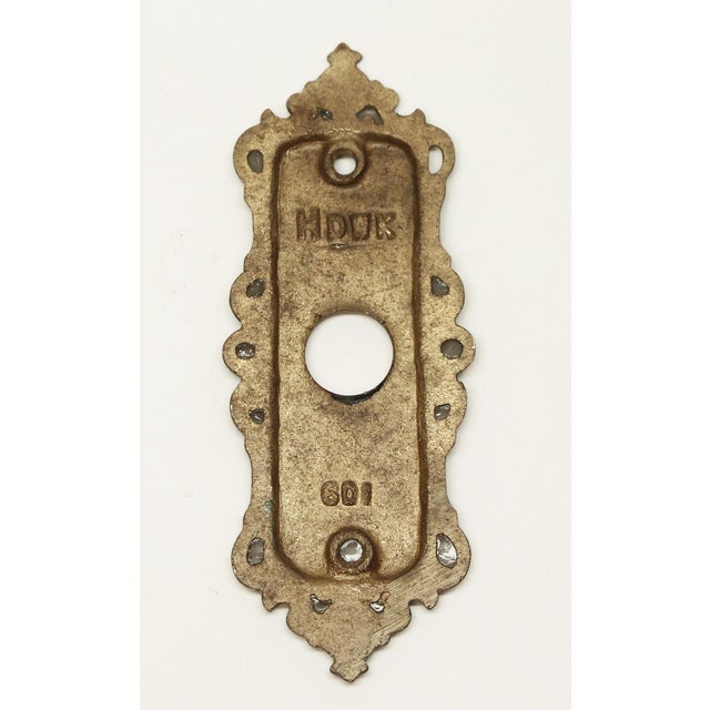 Victorian style brass door plate with decorative edges. Inscribed HDWK. 601. The original mounting screws are not...