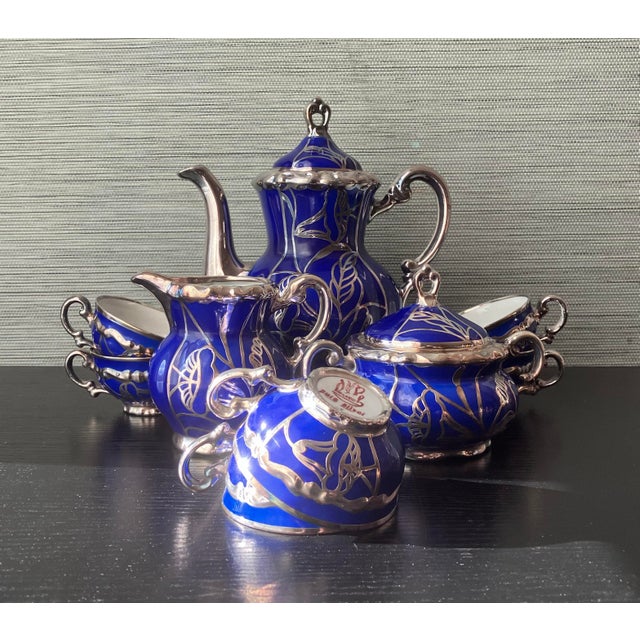 Elegant antique tea service by Deusca Porzellan of Württemberg, Germany, crafted in rich cobalt blue porcelain with...