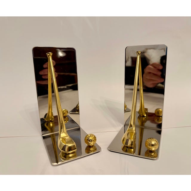 Set of brass and chrome golf bookends featuring brass club and ball with nice detail. Thin foam on bottom to prevent...