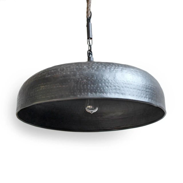 Industrial hammered dome shape lamp in blackened antique bronze finish. Includes hanging rope and ceiling plate. Length...