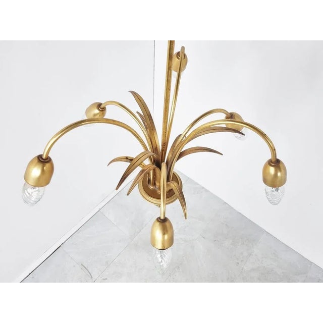 Elegant brass pineapple leaf chandelier by Boulanger, a Belgian lighting company. Hollywood Regency style. It is in good...