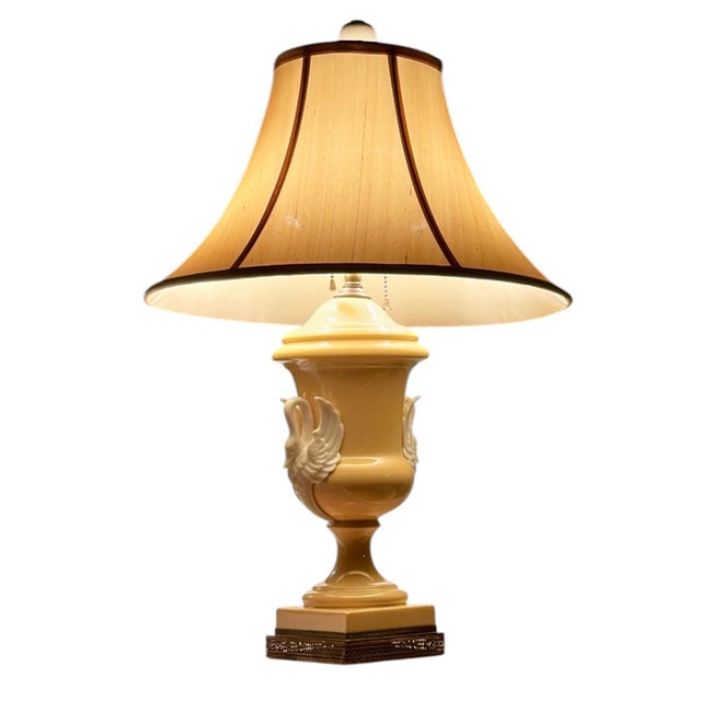 This antique French porcelain lamp features an elegant urn silhouette in a soft buttery yellow glaze. Flanked by detailed...