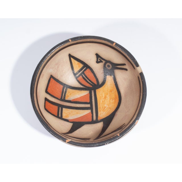 A pottery bowl by the Santo Domingo pueblo potter Warren Coriz. Signed to the underside, the bowl has a stylized bird...