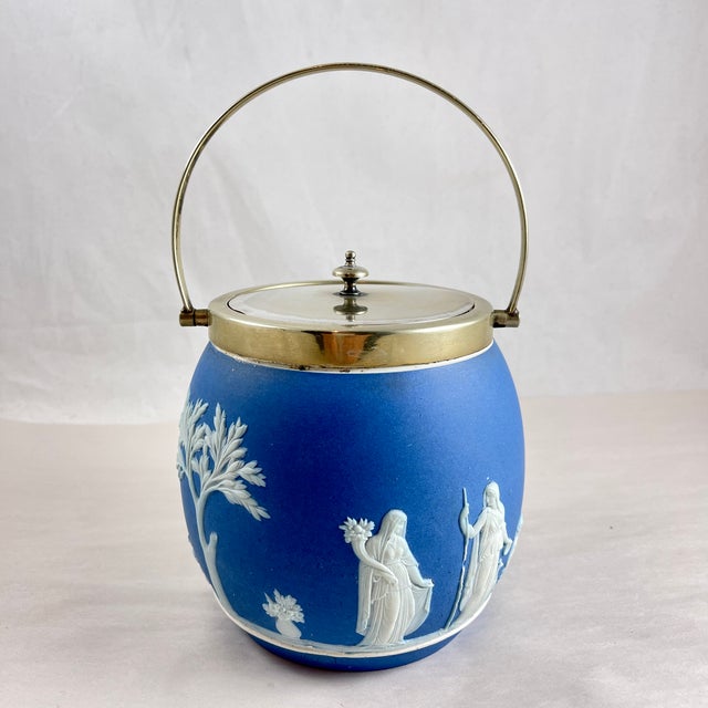 A Wedgwood Jasperware Royal blue Biscuit Barrel with an EPNS lid and swing handle, England, circa 1910-1930. The barrel...