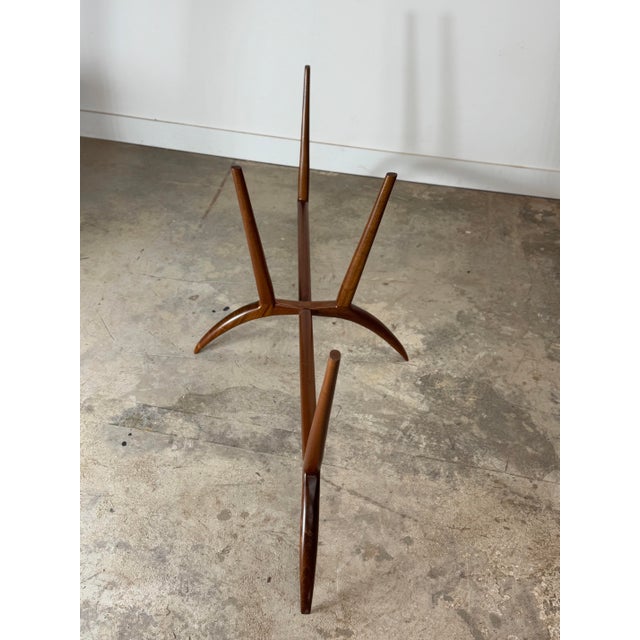 Newly constructed sculptural table featuring a hand-crafted solid mahogany base and an elliptical 88” x 44” glass top....