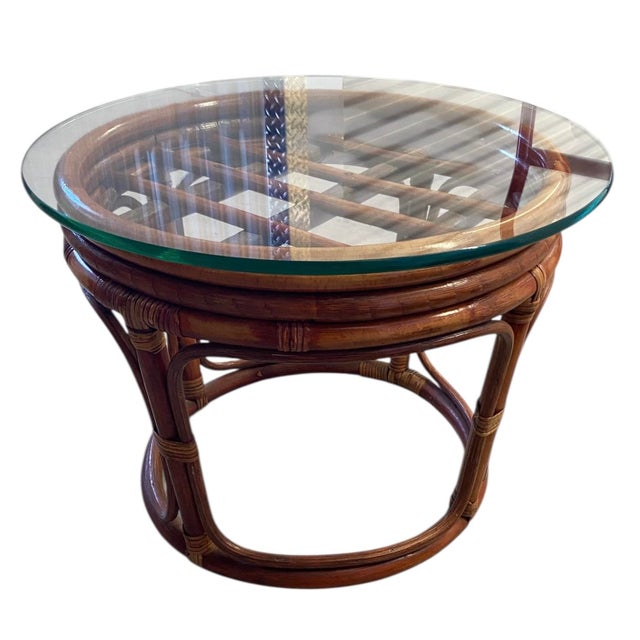 Beautiful vintage rattan and bamboo side table featuring a classic round form with sculptural bentwood legs and woven cane...