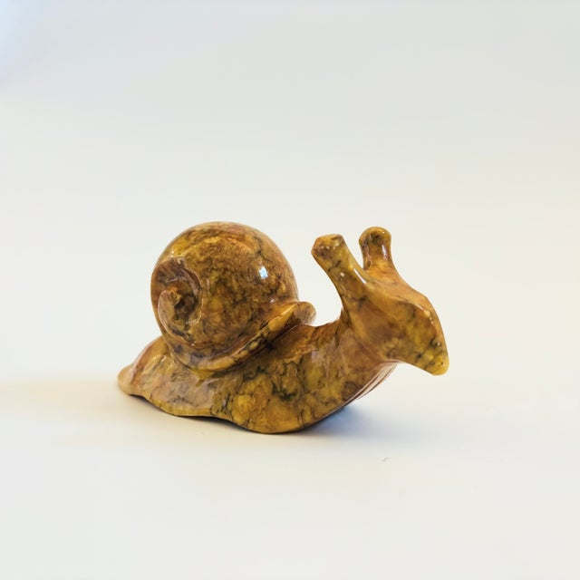 A vintage alabaster stone snail figurine. Lovely natural veining to the stone in an ochre color. Made in Italy, original...