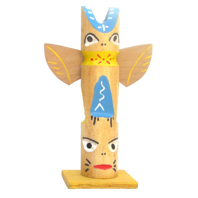 Pair of whimsical and colorful artisan-made painted wood totem pole sculptures believed to be from the 1960s. Vintage...