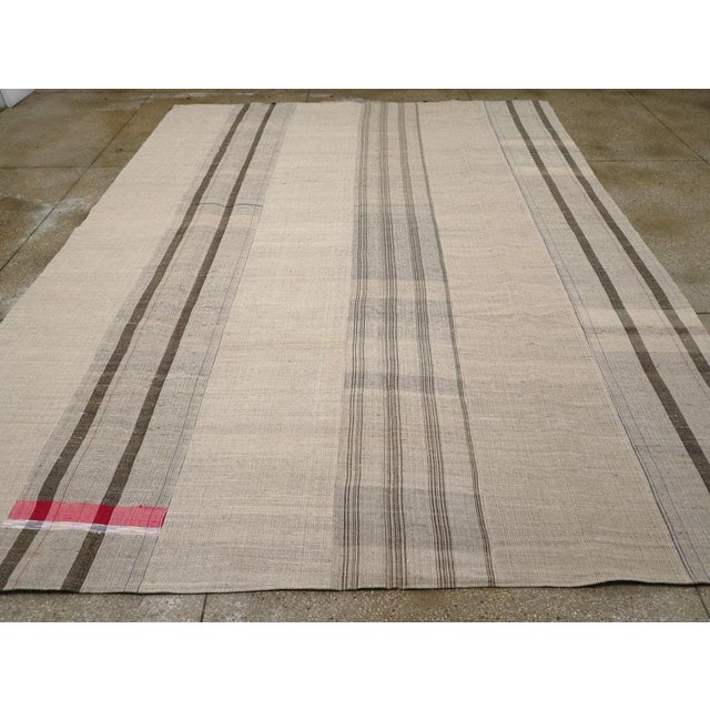A vintage Turkish flatweave Kilim room size carpet handmade during the mid-20th century. Measures: 10' 7" x 14' 1".