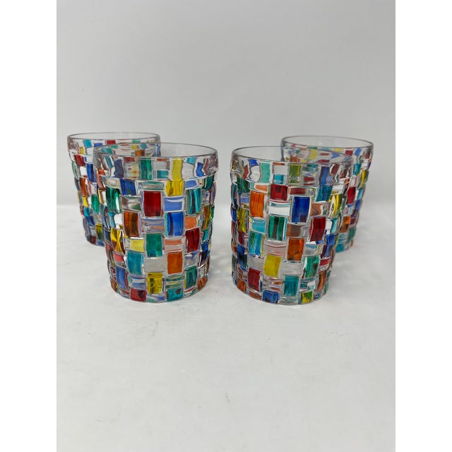 This lovely set of four glass tumblers features incredible colors and would be a wonderful addition to any room....