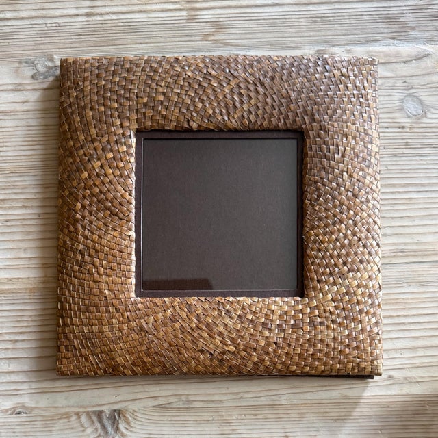 Vintage handwoven rattan photo frame made in the Philippines. The square frame features a richly textured woven natural...