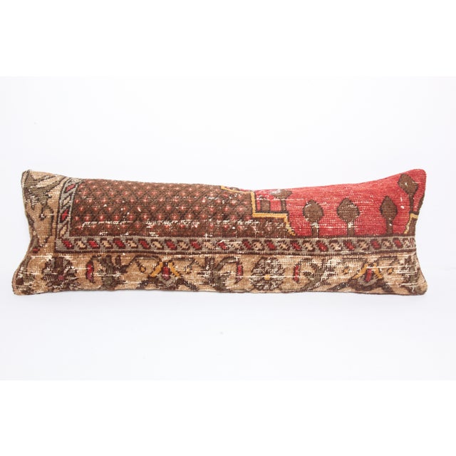 This handcrafted lumbar pillow cover is made from a vintage tribal Turkish Rug, showcasing a beautifully aged patina and...