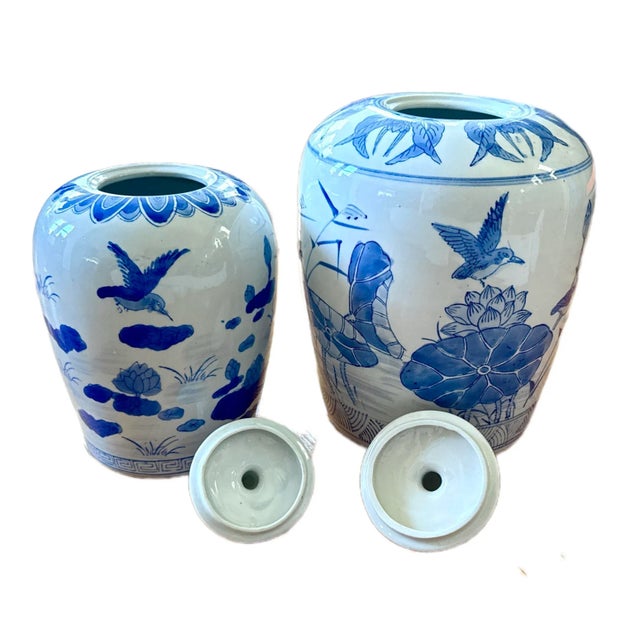Pair of Blue and White Porcelain Ginger Jars A striking duo of hand-painted porcelain ginger jars featuring traditional...