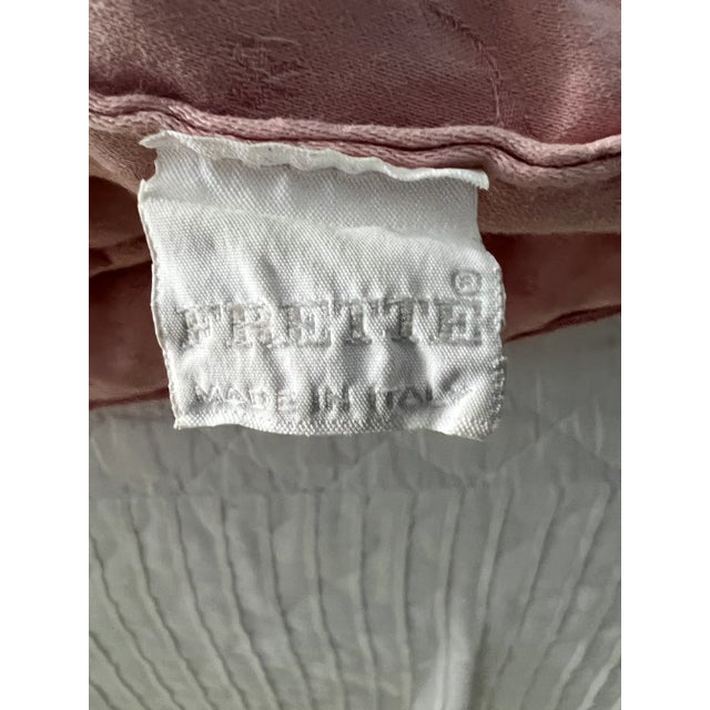 This Frette comforter is made in Italy, ca 1980’s. It has a delicate pattern of interlacing ribbons, here and there tied...