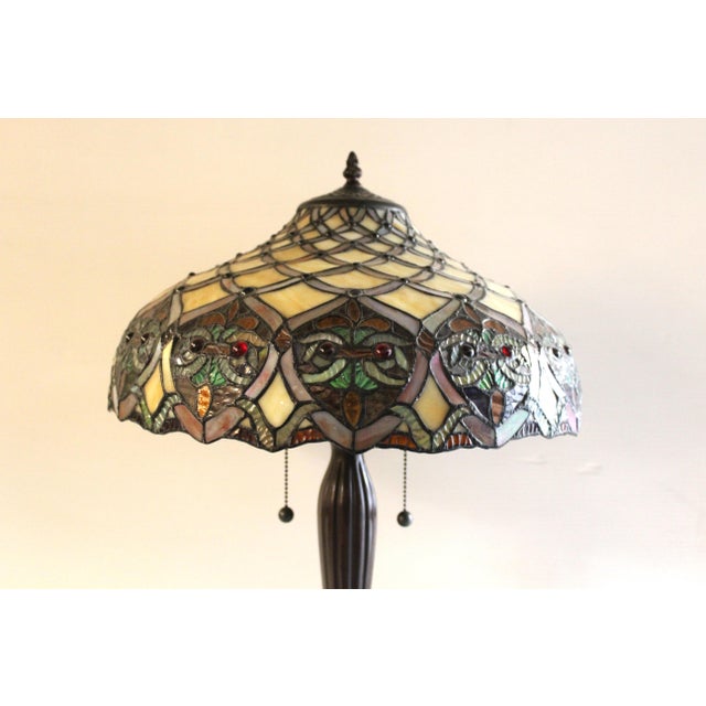 An elegant 20th century Tiffany-style lamp, noteworthy for its unique shade and two pull-switches. The shade itself is in...