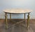 This beautiful coffee table is made of brass with a travertine top. It is a French work in the style of Maison Ramsay....