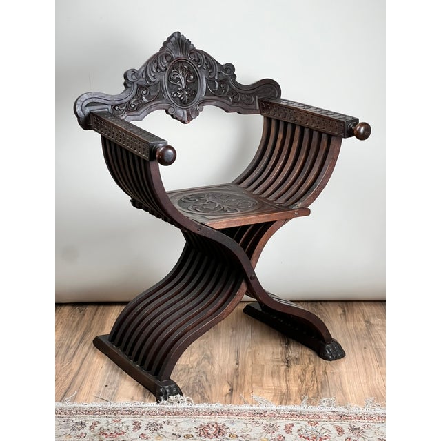 A late 19th century Italian Renaissance Revival Savonarola chair with a bold architectural form and richly carved detail...