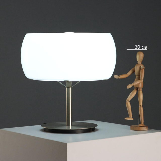 Table lamp, made of metal and white milk glass (opal glass), fitted with an E27 light socket. This piece is attributed to...