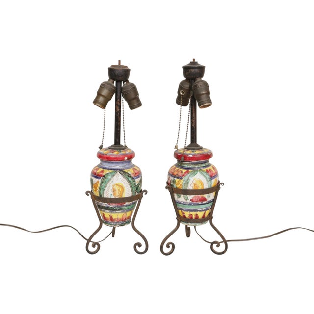 A pair of Italian majolica ceramic and wrought iron table lamps circa 1910. Ceramic vases are decorated with Sgraffito. A...