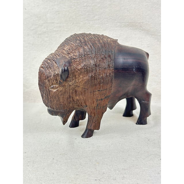 Lovely hand carved vintage buffalo figurine. Made of ironwood. Heavy weight. Perfect to use as a bookend or door stop....