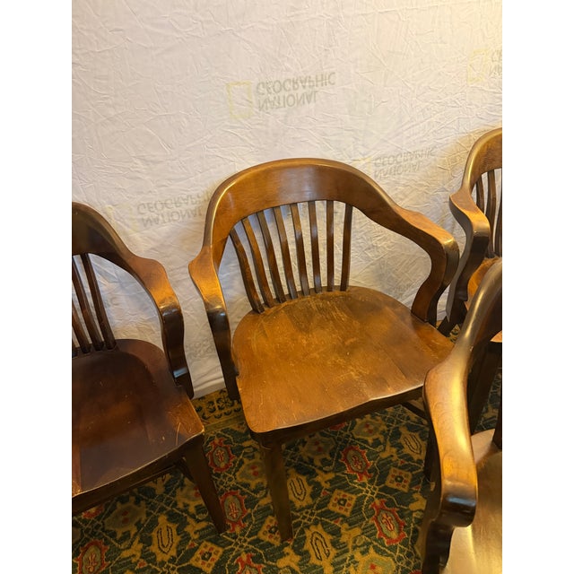 Up for auction is a matching set of six (6) vintage solid wood banker's (captain's) chairs manufactured by The B. L....