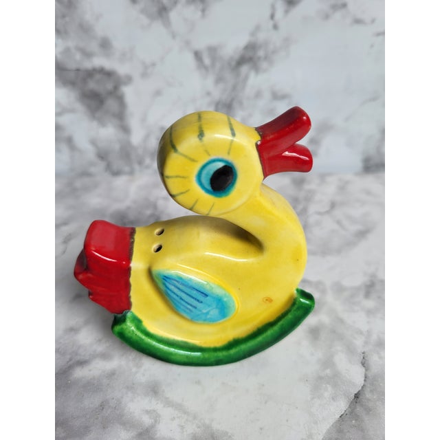 This hand painted porcelain salt shaker would be a fun addition to your table or collection. Painted in the modernist...