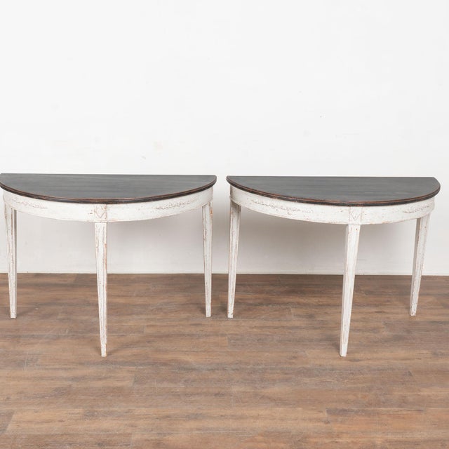 Pair, Gustavian demi-lune pine side tables or consoles with gently tapered fluted legs and decorative applied carving...