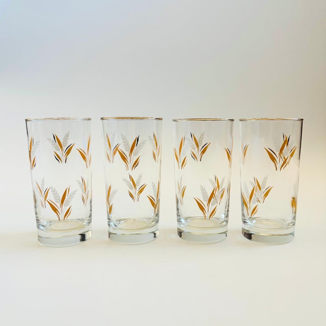 A set of 4 mid century tumblers with a lovely wheat design on the surface in orange, white, and metallic gold. Perfect for...