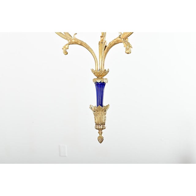 French 19th century slender chandelier made of cast, gilt bronze and accented with a spike at the bottom in cobalt ceramic...