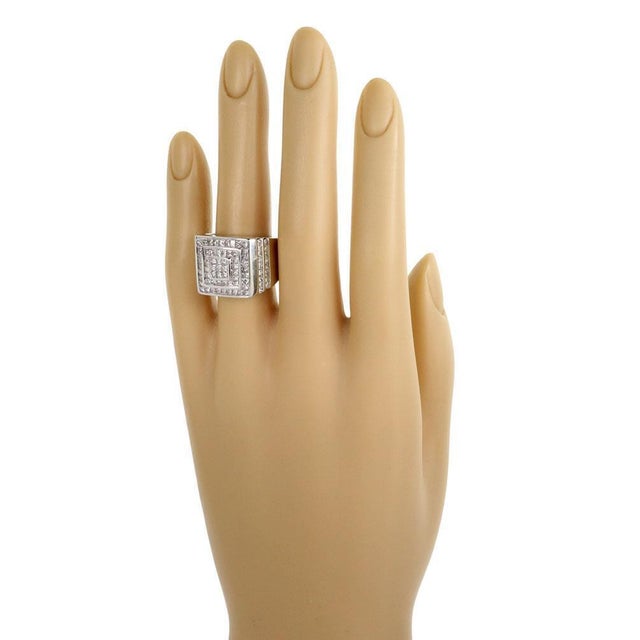 This is an eye catching diamond ring, it is crafted from 14k white gold with a polished finish and features a 3 tier squar...