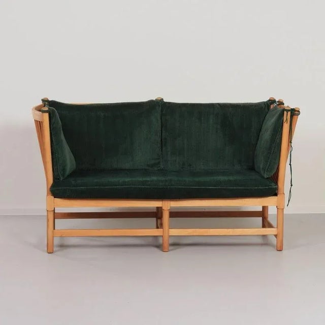 Early edition of the Spoke-Back two-seater sofa designed by Borge Morgensen (1914-1972) for Fritz Hansen. Made in its...