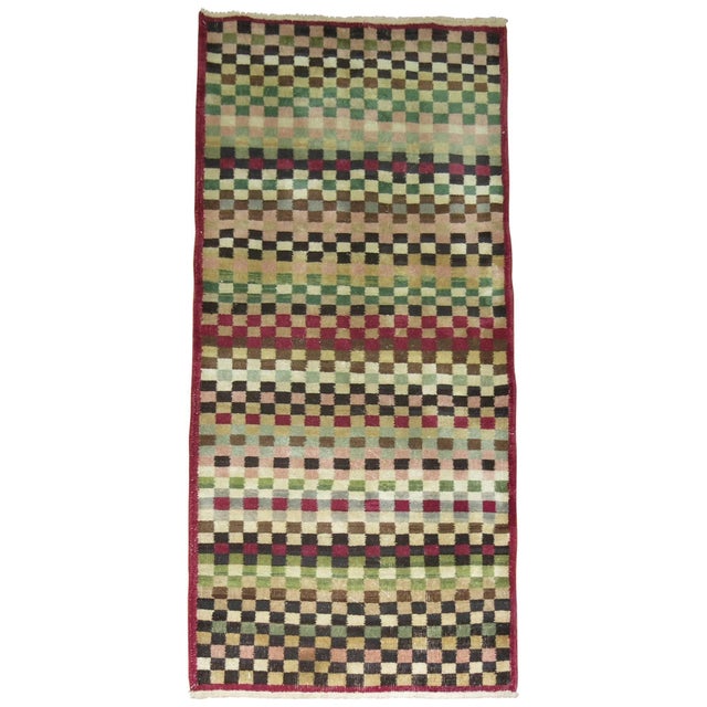 Mid-Century Turkish deco runner with an all-over checkerboard design. Plum , green, brown, pink and ivory acccents are...