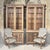 A pair of monumental Gothic Revival display bookcases in solid oak, designed with architectural height and elegant...