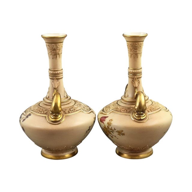 A refined pair of Royal Worcester blush ivory porcelain vases produced in 1902 and 1903. Distinguished by their gilded...