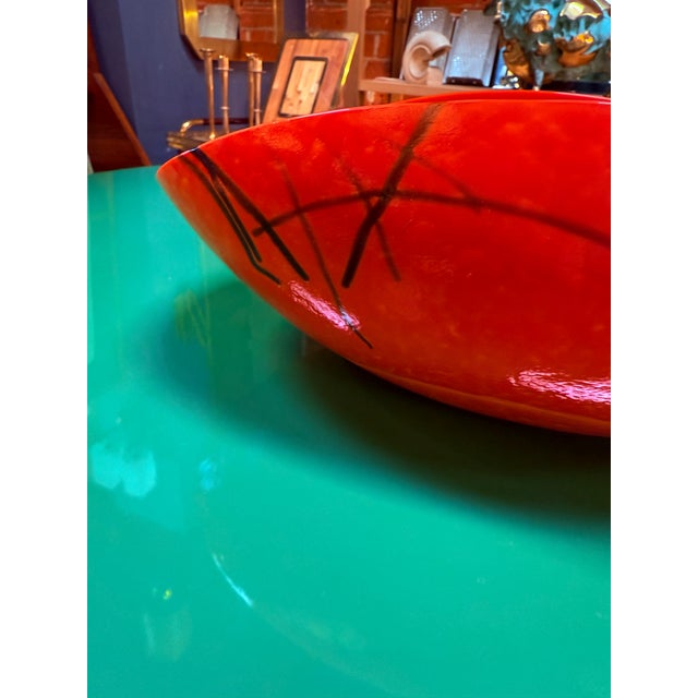 This striking Murano glass bowl showcases the bold artistry and craftsmanship of Italian glassmaking. Handblown in a...