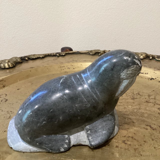 Inuit style soapstone sculpture depicting a sea lion. The sculpture is numbered 24837 Signed J.W. Canada Eskimo Art seal.