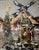 A single figure, presumably the miller of the title, stands within a composition built from gold leaf and layered oil in...