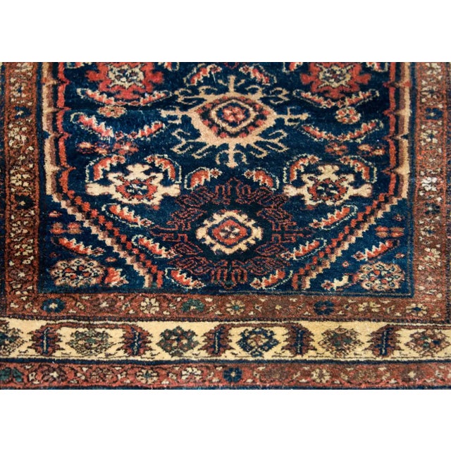 A stunning early 20th century Persian Hamadan rug with a beautiful all-over stylized floral pattern woven in crimson,...