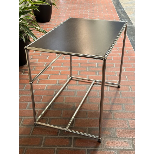 Early USM table with original black laminate top. This could be used as a small desk but is a bit low for most chairs.