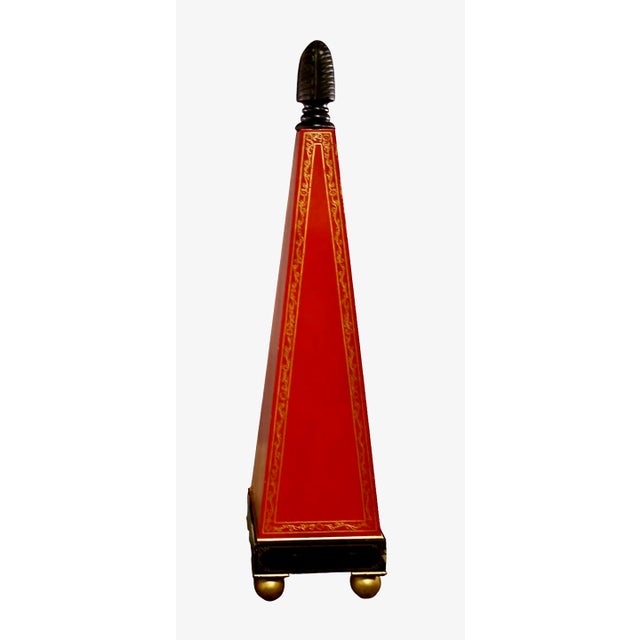 This is a stunning and very unusual pair of 67inch tall painted wood obelisks. The obelisks are painted in an orangey-red...