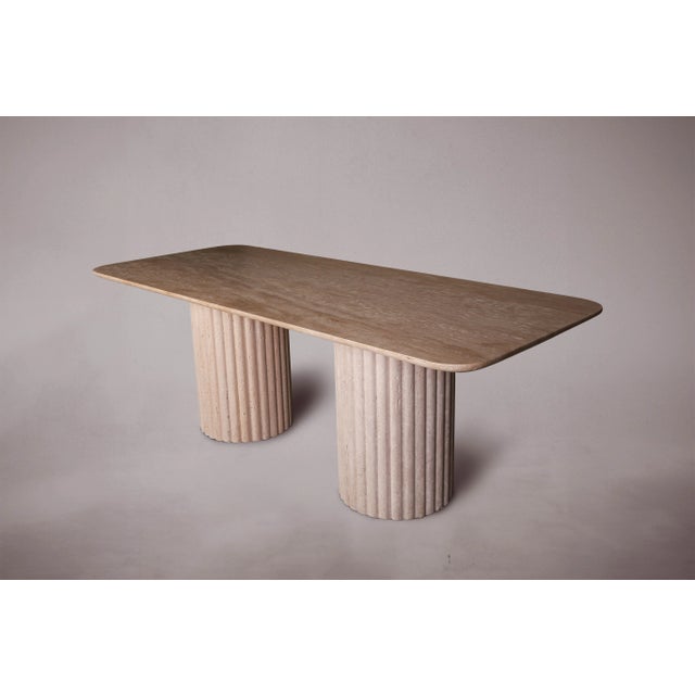 Elevate your dining experience with our exquisite Travertine Dining Table featuring cylindrical legs and vertical stone...