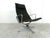 Elegant and timeless Eames EA124 swivel chair. The chair is upholstered in the original black fabric. The chair has a tilt...