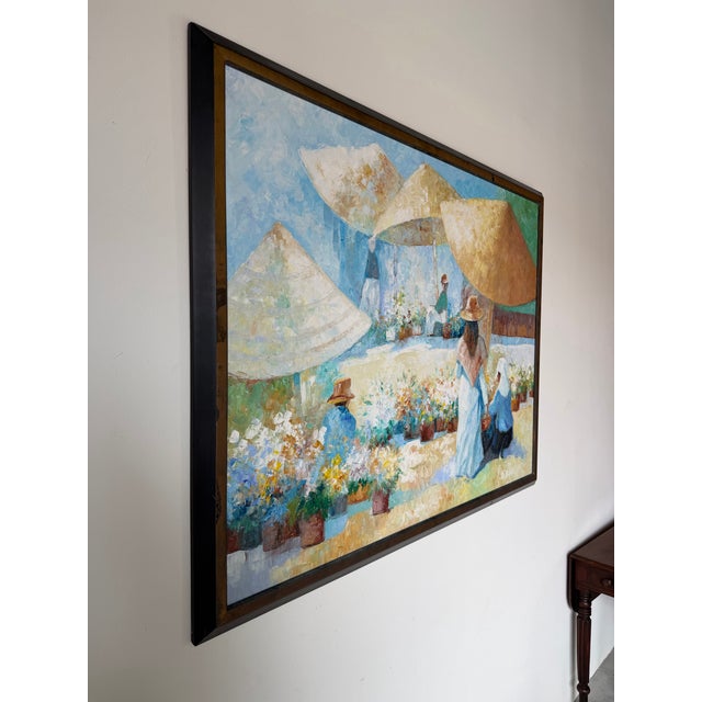 A beautiful 1970s original oil on canvas by listed artist John Adamos Manol, depicting a charming outdoor florist market...