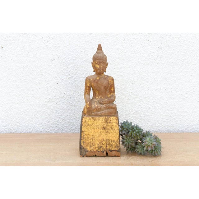 This serene antique gilded Buddha is a testament to time and devotion. Likely originating from Southeast Asia (Thai or...