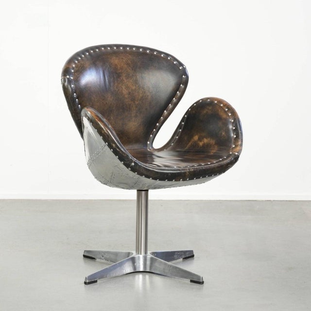 This vintage Aviator accent chair/desk chair by Timothy Oulton in the Devon Spitfire model is made of cowhide leather and...