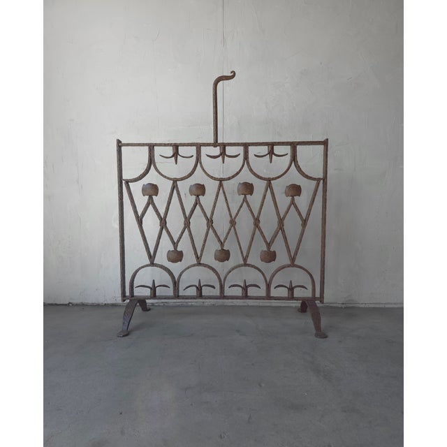 This is a beautiful Antique Art Deco fireplace screen. Handmade of solid iron, this piece is as substantial (50+lbs) as it...